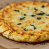 Keto cottage cheese egg pizza crust on baking sheet